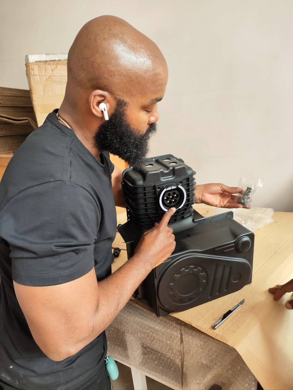 Customer engineer pointing at the connector interface on the bench
