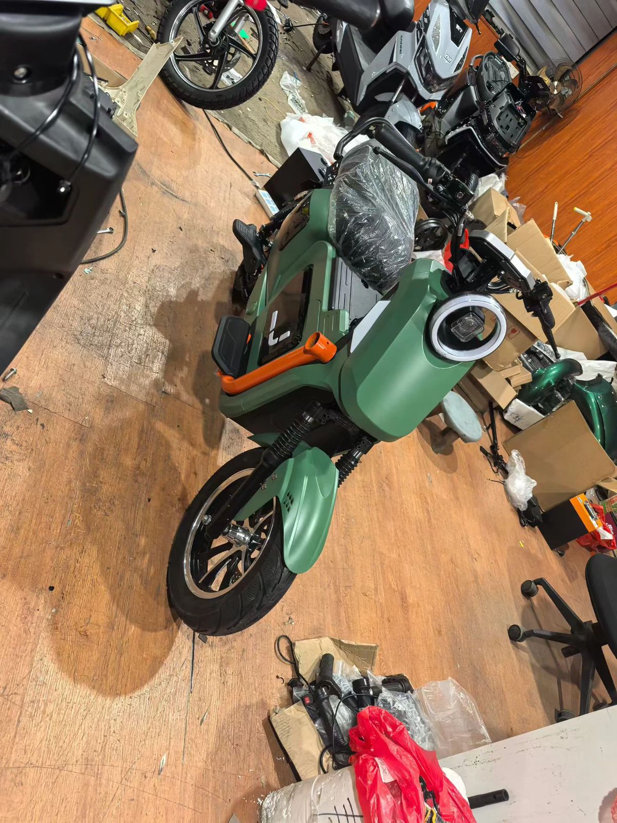 Side view of the matte-green scooter prototype