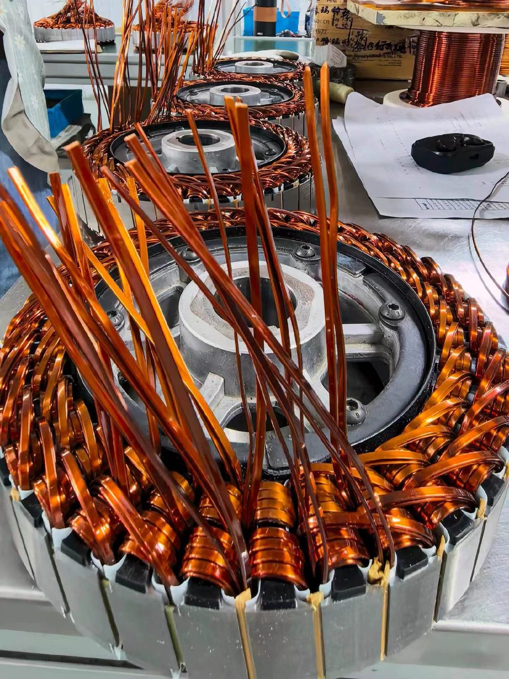 Motor stator being wound with copper magnet wire on the production bench